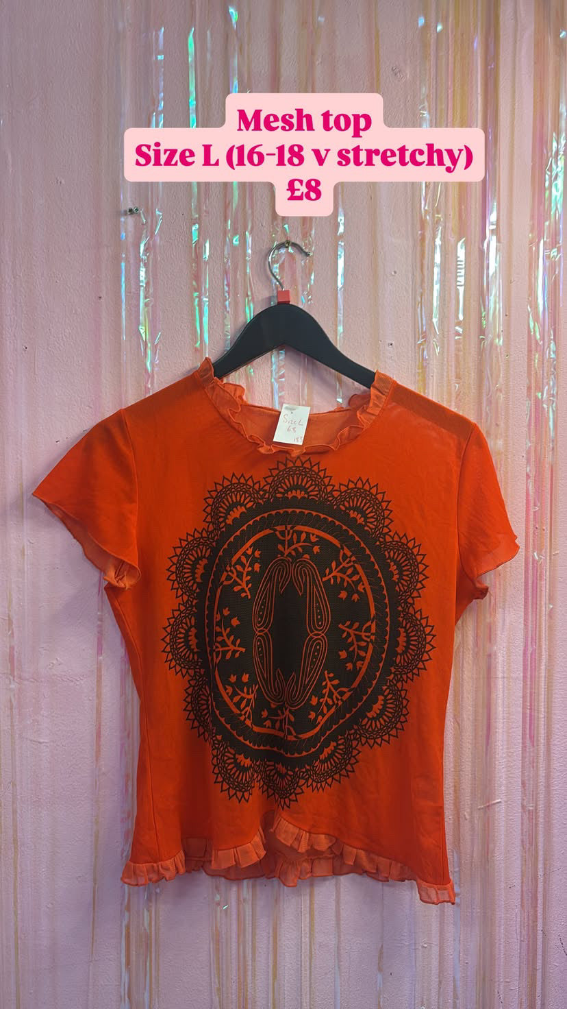 Orange black graphic mesh top